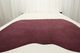Genuine bordo wine leather suede displayed on a table 