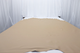 Picture of Morning Khaki, warm tan colored leather hide for upholstery displayed on a table