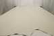 Picture of a pearl colored smooth grain leather for upholstery displayed on a table 