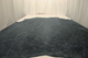 Picture of cool grey/black distress upholstery leather displayed on a table