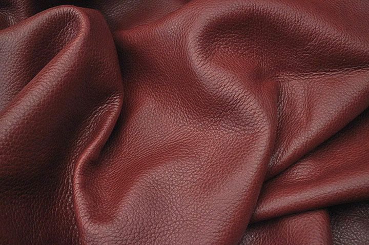 Picture showing the characteristics of warm deep red premium full grain leather for upholstery