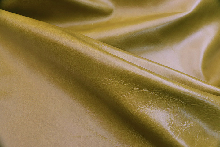 Close up picture of warm Pistachio semi aniline upholstery leather 