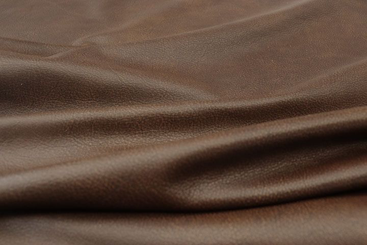 Close up picture of Vintage Redwood, a warm reddish brown leather and natural grain texture.