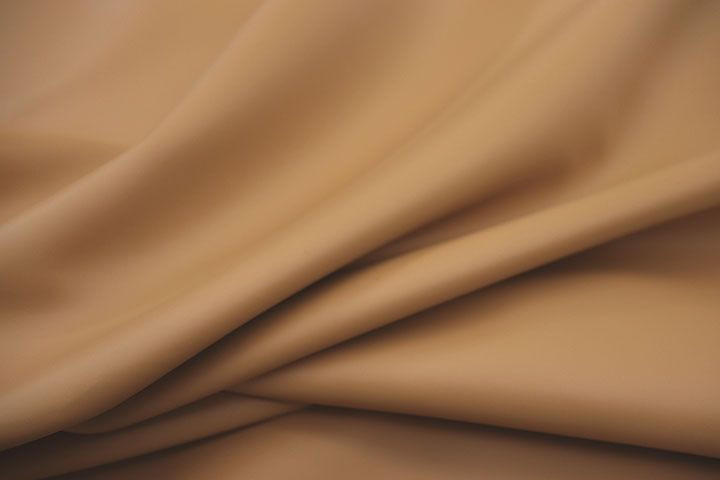 Close up picture of warm golden tan smooth leather for upholstery