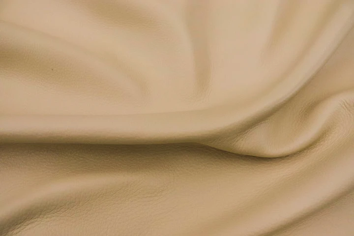 Close up of buttercream color premium top grain leather for upholstery