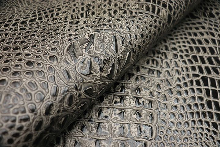 Picture of Outlaw ivory and black, embossed leather with hornback print showing scales and grain.  