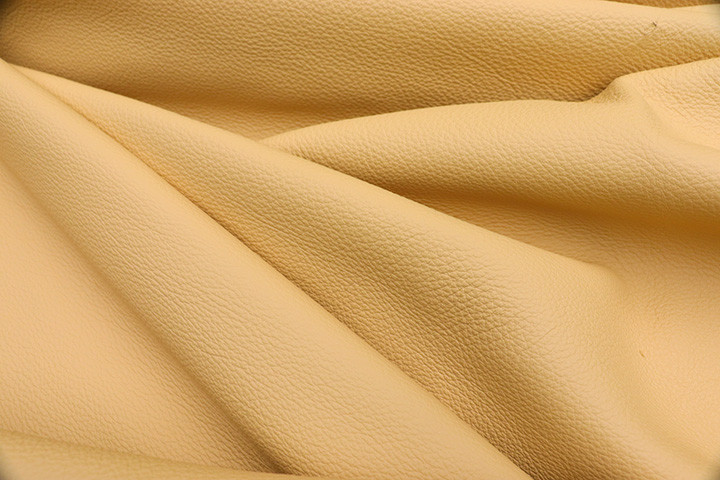 Close-up picture of Western Sun, soft yellow full grain leather for upholstery with pebble grain texture