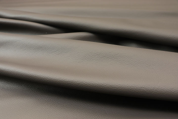 Close-up picture of Graphite Dust soft medium grey leather for upholstery with natural grain texture.