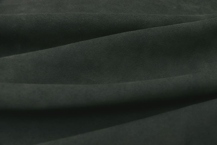 Closeup picture of soft forest green suede showing texture of leather