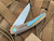 Hog House Knives Model T Bronzed Titanium Body w/ Light Blue Anodized Titanium Hardware and Blasted RWL-34 Blade (3.36”) HHK-T-BR-BZLBL