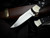 Buck Knives 112 Auto Elite Folding Knives Black G10 Inlaid Nickel Silver Body w/ Magnacut Plain Edge Blade (3") 0112BKSA-B