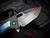 Heretic Knives Custom Medusa Manual Folder Entropic Anodized Titanium Inlaid Carbon Fiber Body w/ Elmax Hand Ground DLC Tanto Plain Edge Blade (3")