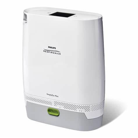 Philips Respironics SimplyGo Mini Oxygen Concentrator with Extended Battery, compact portable oxygen device showing a sleek white design with a digital display and green power button.