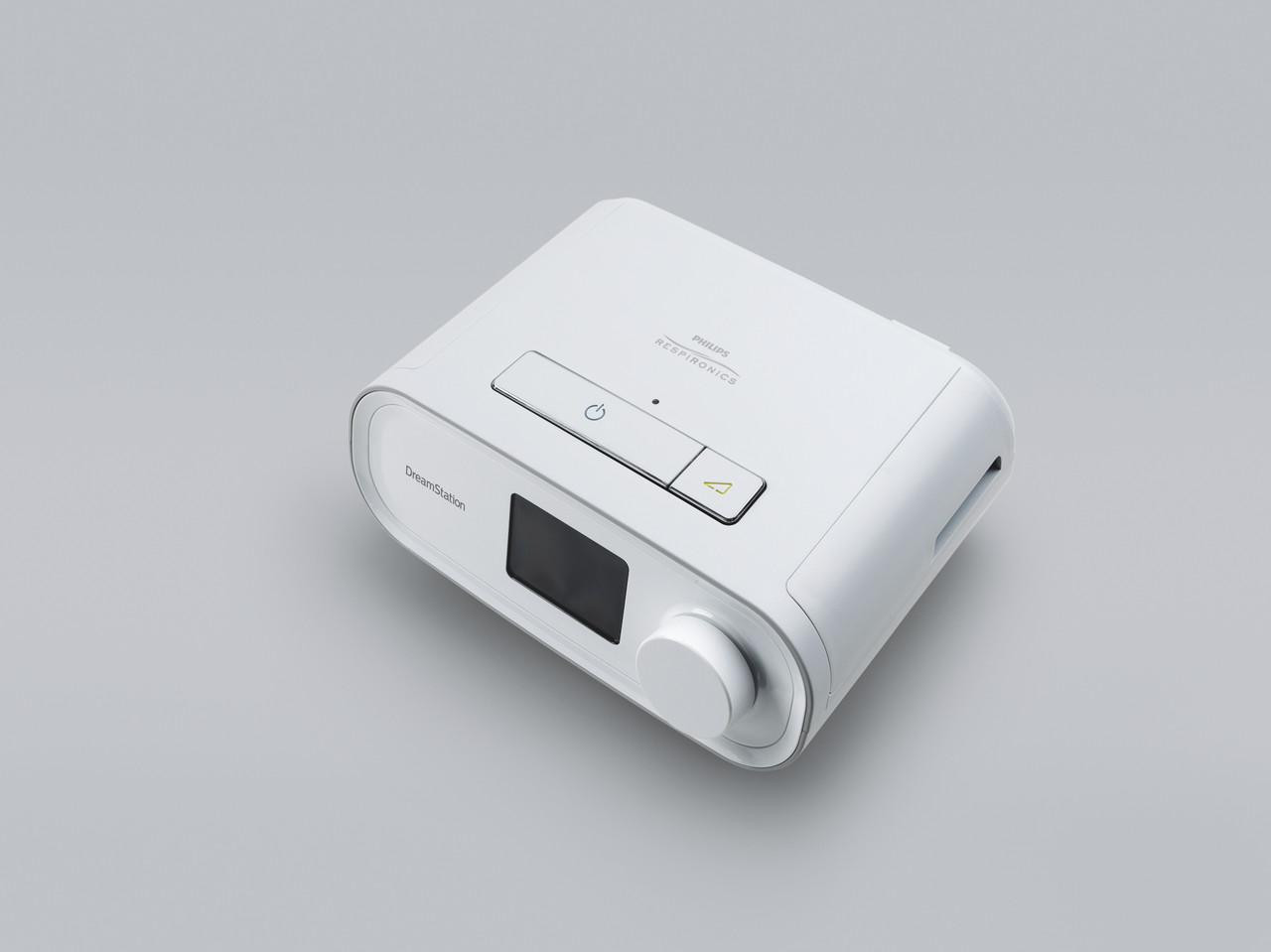 Philips Respironics Philips DreamStation Auto + Mask Package + Modem + Bonus Accessories, compact white medical device for sleep therapy with control buttons and display screen.