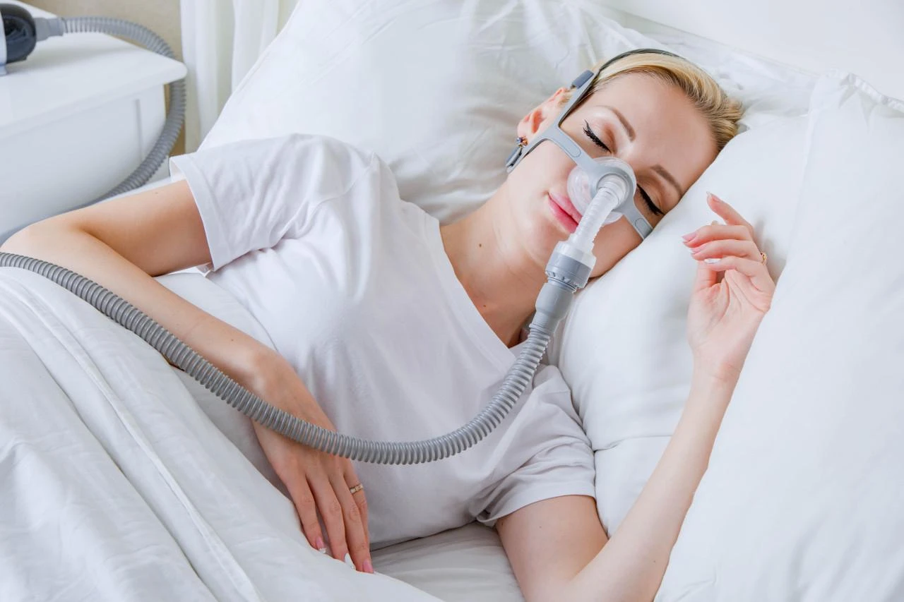 BMC N5AH Nasal Mask, woman sleeping with nasal mask on her face for sleep apnea treatment.
