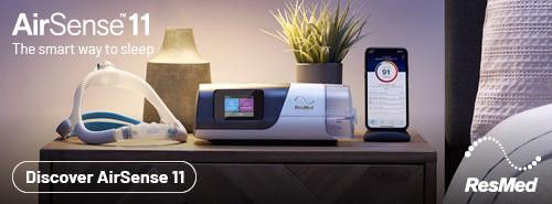 Resmed Airsense 11 Auto Super Value Package, sleep apnea therapy device with accessories displayed on a bedside table.