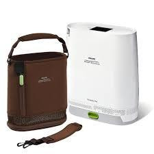Philips Respironics Simply Go Mini Oxygen Concentrator with standard battery, portable medical device for oxygen therapy, accompanied by a brown carrying case.