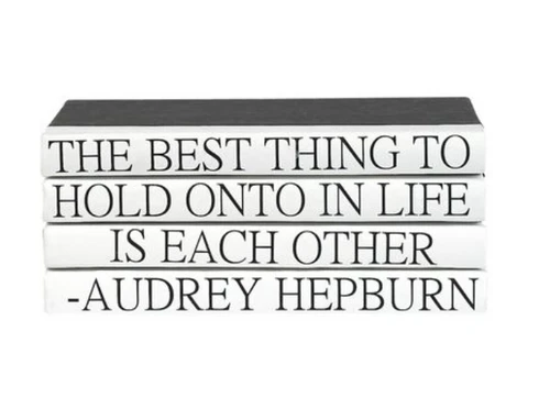 "The Best Thing to Hold onto in Life is Each Other" quote on decorative hardbound/repurposed books.