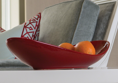 Oblong red glazed ceramic bowl is great on its own or on a table setting at your next party.