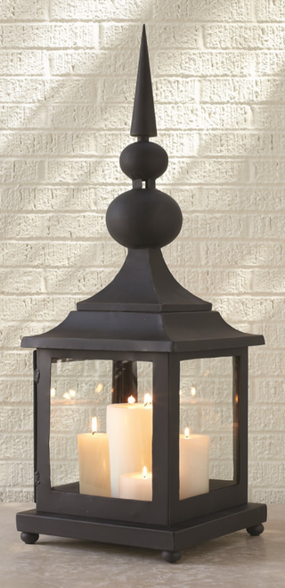 Let our Iron Maison Lantern light your way. At the center of the iron frame is a large space that will accommodate multiple candle sizes and is enclosed by clear glass.