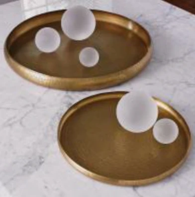 Hand-embossed brass trays like these were used for serving or as offering trays in religious ceremonies.