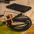 Charge cable stowed with retention clasp and adapter