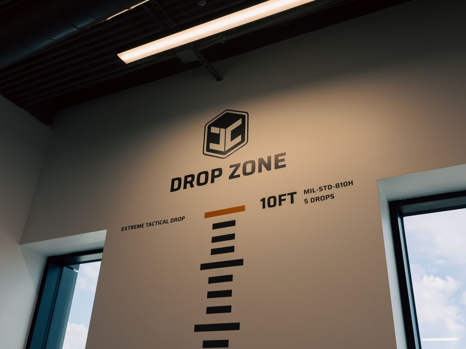 Drop zone testing setup for repeatable 4 ft to 10 ft drops onto steel