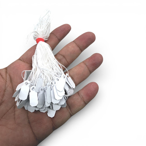 White Strung Parcel Tags with Cotton String, product shown against a coloured background