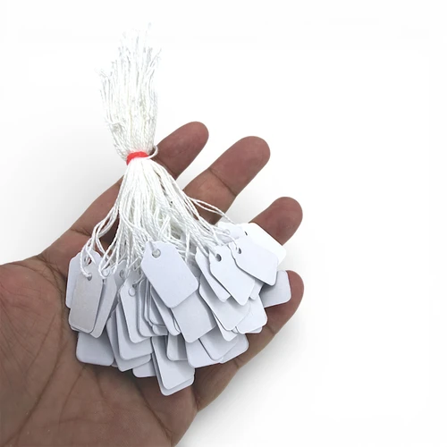 White Strung Parcel Tags with Cotton String, product shown against a coloured background