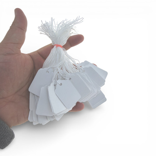 White Strung Parcel Tags with Cotton String, product shown against a coloured background, balanced, centred square layout