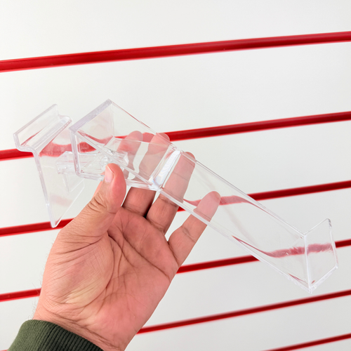 Hand holding the clear acrylic rotating shoe display stand