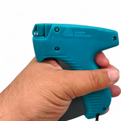 Avery Dennison Mark III 10651 Tagging Gun, printed product shown against a coloured background, balanced, centred square layout