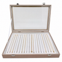 Open rose-gold jewellery box displaying rows of gold and silver chains