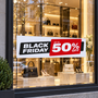 Black Friday up to 50% off poster in a boutique window above handbags
