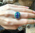 Blue Sapphire with Emerald and Diamond Ring Set in 18 Karat White Gold Settings