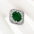 Platinum GIA 5.59 Carat Oval Emerald and Baguette Diamond Wave Ballerina Ring