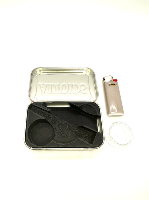 Open view of the custom 3D-printed storage insert nestled inside a standard metal pocket tin, highlighting dedicated slots for a mini lighter, an ingredient jar, and the Vessel Cone.