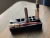 ush Kitteh 3D-printed angled desktop cartridge organizer stand holding 8 individual storage pieces cleanly.