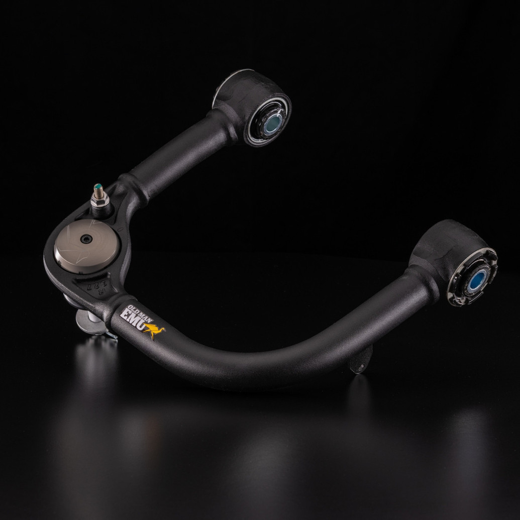 Old Man Emu Upper Control Arms UCA0004, black automotive suspension control arm with bushings and mounting points for vehicle upgrade.