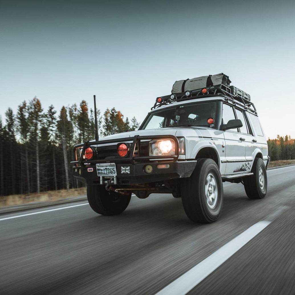 ARB Deluxe Winch Bumper 3432060B, a sturdy off-road vehicle bumper with integrated winch and additional lighting for enhanced vehicle protection and recovery capabilities.