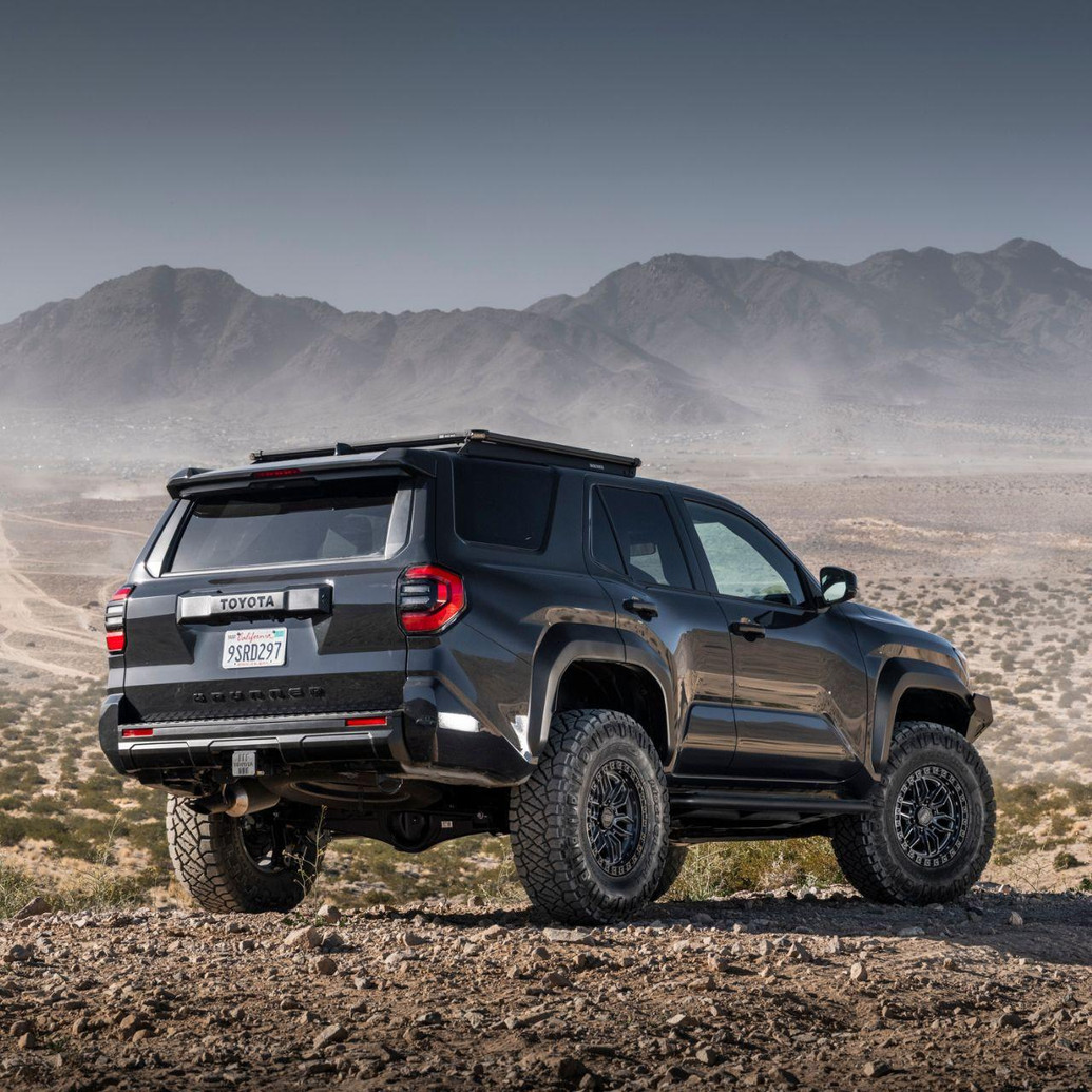 Old Man Emu MT64 Kit FR 3 in/0 lb, RR 0 in/0 lb 2132K, vehicle suspension kit on off-road rugged terrain with mountainous landscape in the background.