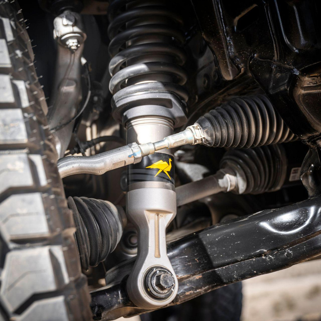 Old Man Emu MT64 3-inch Lift Kit with UCA for Toyota 4Runner (2025+) - Front suspension components, coil spring, control arm, and CV boot, close-up view.