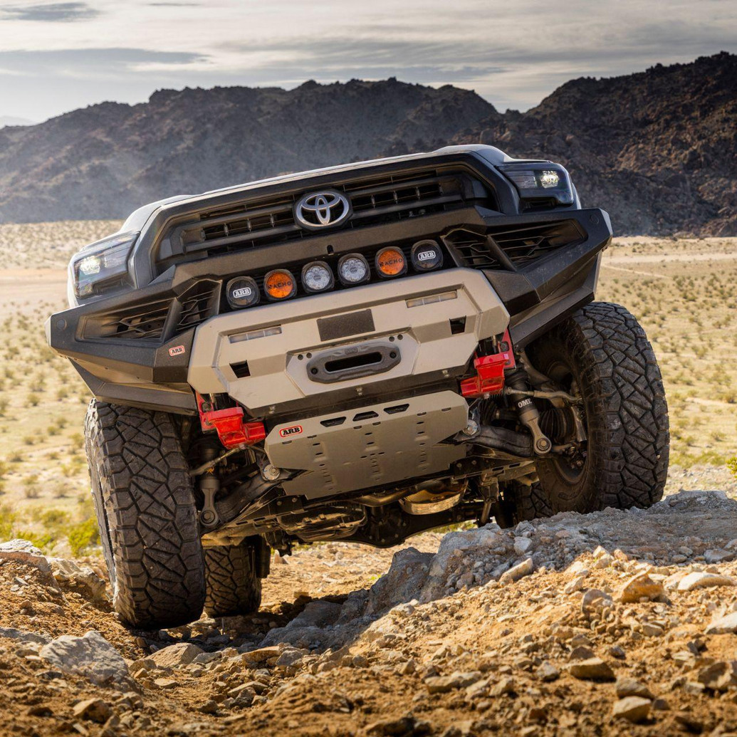 Old Man Emu MT64 Kit FR 3 in/0 lb, RR 2 in/0 lb 2134K, vehicle suspension lift kit, mounted on off-road vehicle in rocky desert terrain.