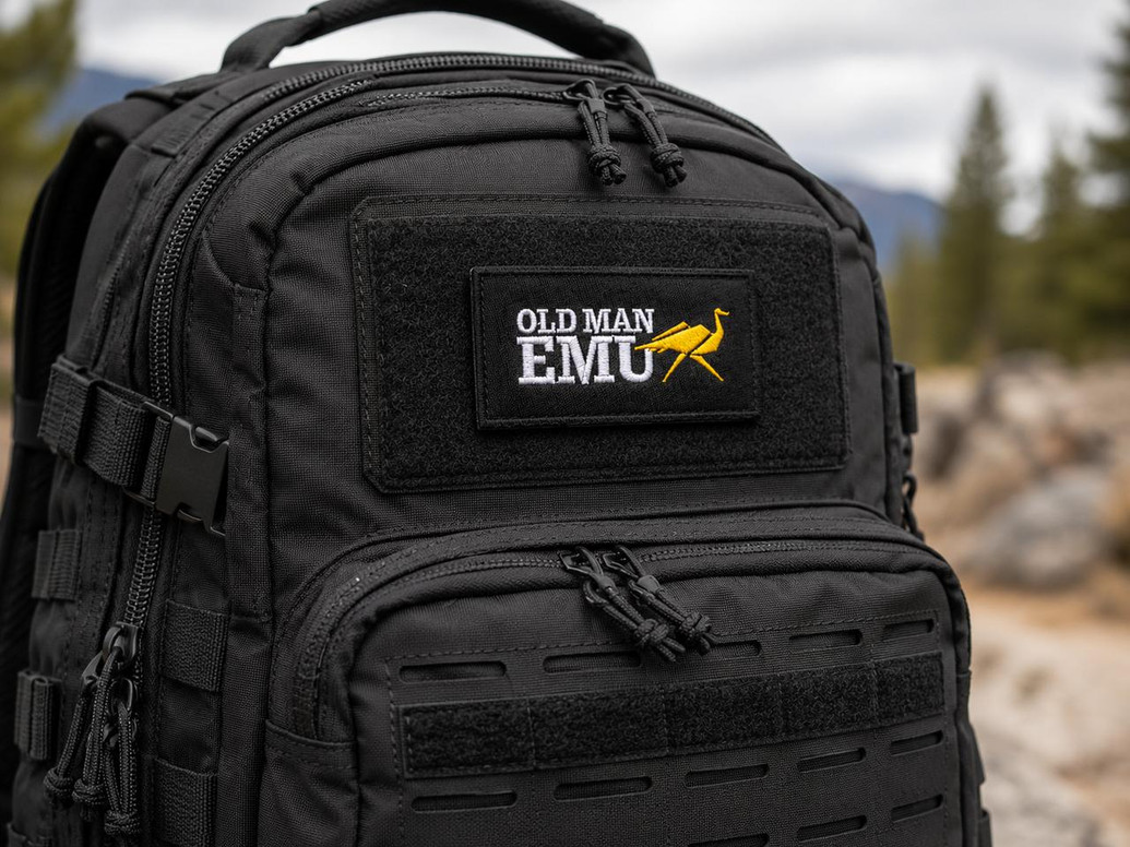 Old Man Emu Embroidered Patch 3.5 inch, black patch with yellow bird logo and white text, attached to a black backpack.