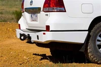ARB Rear Bumper 5615020B, white vehicle rear bumper with tow hook and black accents.