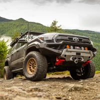 Old Man Emu BP-51 3-inch Lift Kit with UCA for Toyota Tacoma 2024+ - Front view of a rugged off-road truck equipped with the lift kit, showing suspension components and off-road tires against a mountainous background.