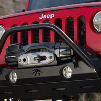 ARB Winch with Synthetic Rope, mounted on a Jeep with a black bumper and red grille, featuring a black bull bar for off-road recovery.