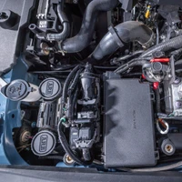 ARB Compressor Mounting Bracket for Toyota Land Cruiser 250, installed in the engine bay with hoses and electronic components visible.