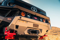 ARB Zenith Winch Bumper for Toyota Tacoma 2024+, front view of the off-road vehicle with upgraded bumper featuring mounted lights and winch compatibility.