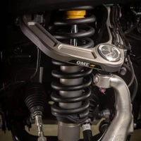 Old Man Emu MT64 Suspension Kit w/FB UCA for Land Cruiser (2024+), Front 3-inch lift, Rear 2-inch lift, and 440 pounds capacity, shown installed on a vehicle's suspension system.